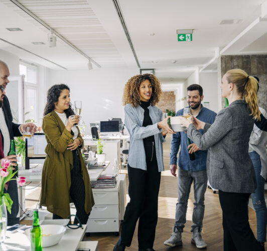 Celebrating a work event and handing a promotional corporate item