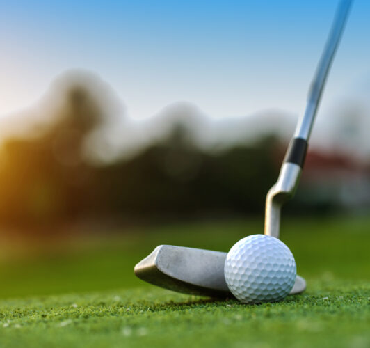 Golf club getting ready to hit the ball