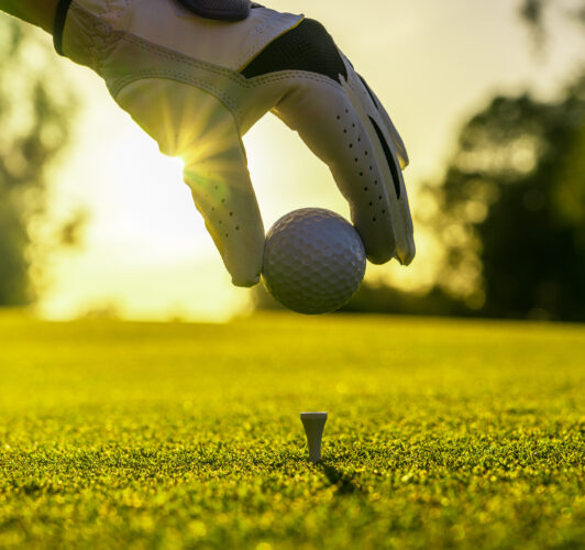 Placing a golf ball on a tee